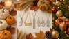 Personalized name and initial necklaces arranged with autumn pumpkins and leaves