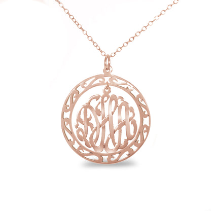 rose gold-plated silver round monogram necklace hanging inside a hollow teardrop pendant