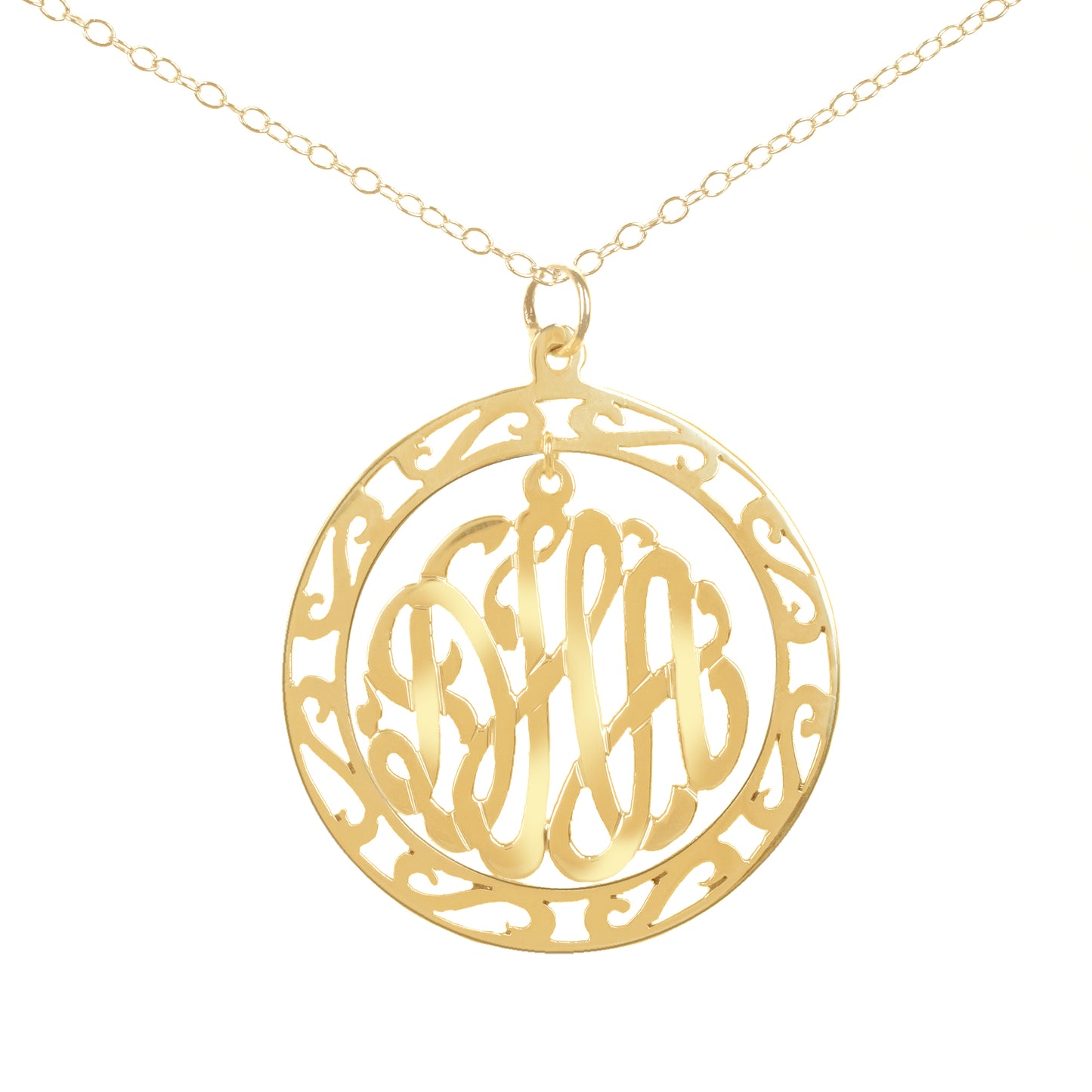 gold-plated silver round monogram necklace hanging inside a hollow patterned circle pendant